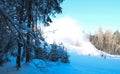 Working snow making machine on ski resort. Snow blower in action. Sunny winter day. Latvia Royalty Free Stock Photo