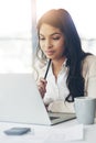 Working on some of her brilliant new ideas. a young businesswoman working on a laptop in an office. Royalty Free Stock Photo