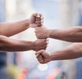 Working on success together. Cropped shot of two unrecognisable businessmen standing together with their fists stacked.