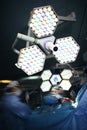 Working surgeons under the shadowless lamp in the surgery room