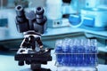 Microscope and rack with sample tubes in the Microbiology Laboratory Royalty Free Stock Photo
