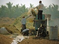Working a threshing machine at harvest time in Gujarat