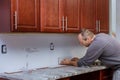 Tile grouting applying grout to the joint tiles for home improvements to a kitchen Royalty Free Stock Photo