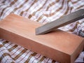 Wood carving chisel getting sharpened on a stone Royalty Free Stock Photo