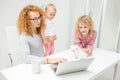 Working together with children .mother with adopted children using laptop Royalty Free Stock Photo