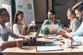 Working together. Group of young modern people in smart casual w Royalty Free Stock Photo