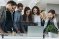 Working together. Group of young modern people in smart casual wear discussing business and smiling in the creative office