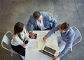 Working together. High angle shot of three businesspeople working in the office. Royalty Free Stock Photo