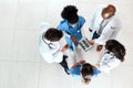 Working together like a well oiled medical machine. High angle shot of a team of doctors using a digital tablet to Royalty Free Stock Photo