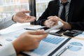 Working together in office concept, young businessmen using touchpad digital tablet to discuss the situation on the market or stoc Royalty Free Stock Photo