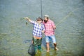 Working together is success. fisherman with fishing rod and net. hobby and sport activity. Trout bait. summer weekend Royalty Free Stock Photo