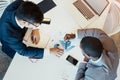 Working together to make the business grow. High angle shot of two young focused businessman making notes while looking Royalty Free Stock Photo