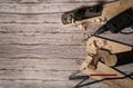 Old metal jointer, folding meter, electric drill, pencil, boards and shavings on wooden background. Royalty Free Stock Photo