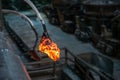 Working tool with glowing metal at a steel mill