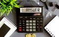 Working tools in office with calculator text ANSWER , phone, coins, notebook Royalty Free Stock Photo