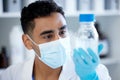 Working towards a new discovery. a young man analysing a sample in a lab.