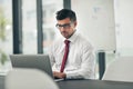 Working towards strict deadlines. a young businessman working in his office.