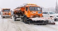 Working truck mounted snow plows on a road during heavy snow in Perm, Russia