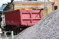 A working truck is preparing to unload gravel on the site to build a parking lot for tourist buses. The upper awning is Royalty Free Stock Photo