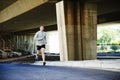 Working up a sweat. Young man keeping fit by going for a run in the city.