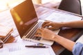 Working by using a laptop computer on wooden table. Hands typing on a keyboard. Royalty Free Stock Photo