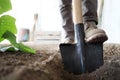 Working in vegetable garden, foot spade the soil