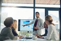 Working through ways to further maximise their profits. a businessman giving a presentation to his colleagues in an Royalty Free Stock Photo