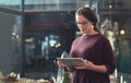 Working wirelessly to ensure success. an attractive young female entrepreneur using a tablet in her store. Royalty Free Stock Photo