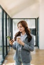 Working woman concept a female manager attending video conference and holding tablet, smatrphone and cup of coffee in office Royalty Free Stock Photo