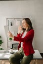 Working woman concept a female manager attending video conference and holding tablet, smatrphone and cup of coffee in office Royalty Free Stock Photo