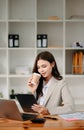 Working woman concept a female manager attending video conference and holding tablet, smatrphone and cup of coffee Royalty Free Stock Photo