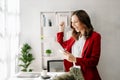 Working woman concept a female manager attending video conference and holding tablet, smatrphone and cup of coffee in office Royalty Free Stock Photo