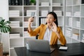 Working woman concept a female manager attending video conference and holding tablet, smatrphone in modern office Royalty Free Stock Photo