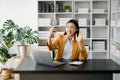 Working woman concept a female manager attending video conference and holding tablet, smatrphone in modern office Royalty Free Stock Photo