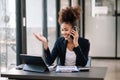 Working woman concept a female manager attending video conference and holding tablet, smatrphone in office Royalty Free Stock Photo