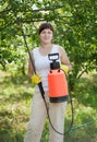 Working woman with garden spray