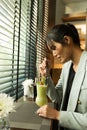 Working woman side rear view having drink fruit Juice Royalty Free Stock Photo