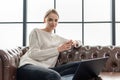 Working Woman sitting on leather sofa Royalty Free Stock Photo