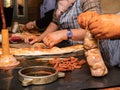 Working women filling the cecum of the pig with chopped and seasoned pieces from the cutting of the pig