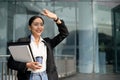 Gorgeous Asian businesswoman in casual clothes walking on the street along the building Royalty Free Stock Photo