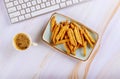 Working on work desk at coffee with french fries and computer on table Royalty Free Stock Photo