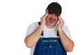 Workman in bib overalls with a migraine headache
