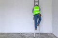 Workman climbing a ladder Royalty Free Stock Photo