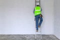 Workman climbing a ladder