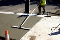 Workman finishes and smooths concrete surface on new sidewalk