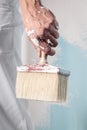 Workman Hand holding Dirty Paintbrush