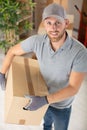 Workman holding cardboard box