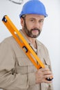 workman holding orange level