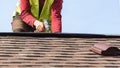 Workman install element of tile roof on new home under construction