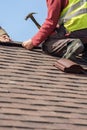 Workman install element of tile roof on new home under construction